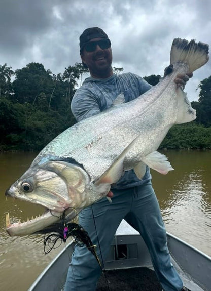 Fisherman with a trophy payara caught on a hand-tied Payara Dragon Fly