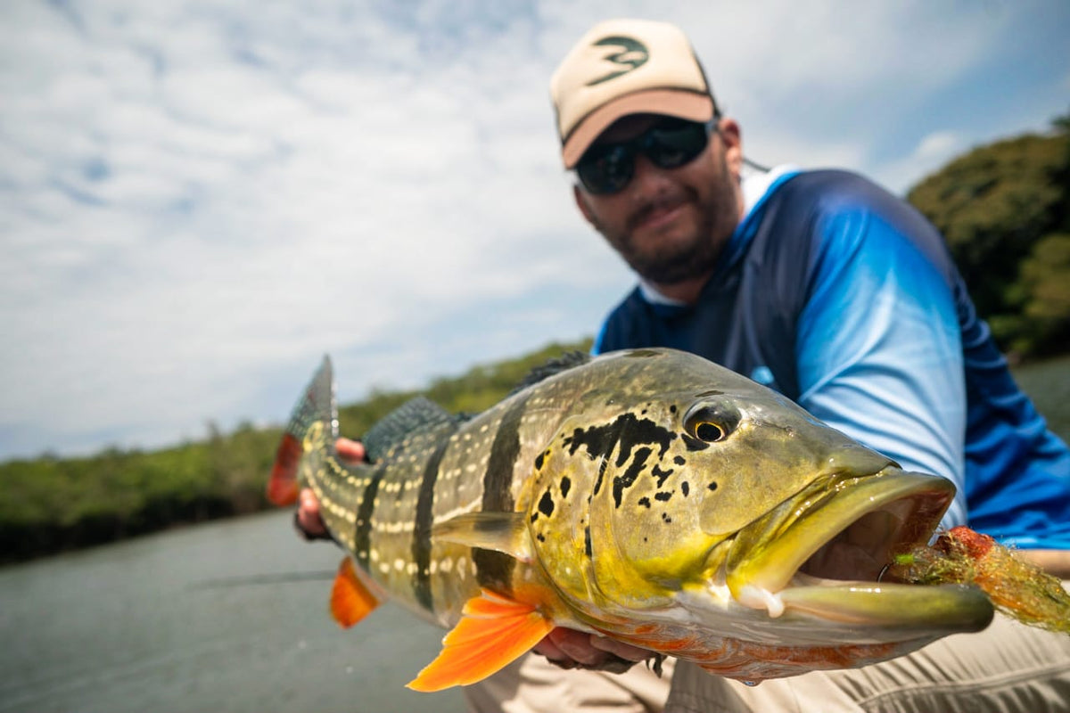 Orinoco Flies founder with a paca peacock bass caught on the Fire Tiger Fly