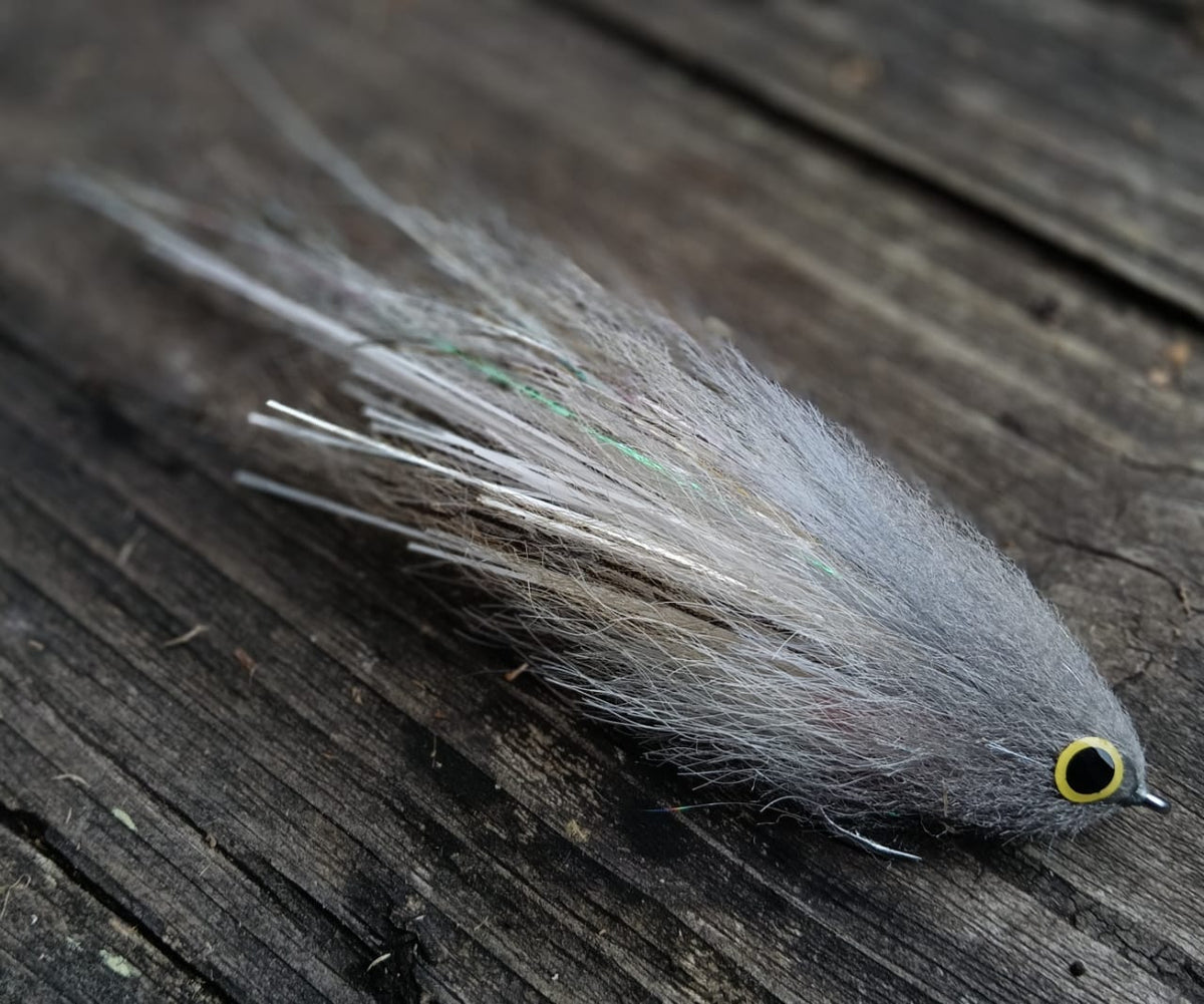 Gray Sabalo fly, hand-tied 6-inch streamer for peacock bass imitating a sabalo baitfish, gray and white with yellow eyes