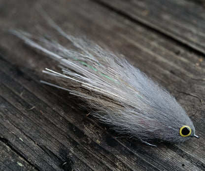 Gray Sabalo fly, hand-tied 6-inch streamer for peacock bass imitating a sabalo baitfish, gray and white with yellow eyes