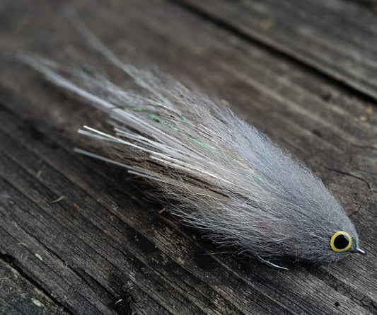 Gray Sabalo fly, hand-tied 6-inch streamer for peacock bass imitating a sabalo baitfish, gray and white with yellow eyes