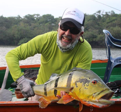 A very happy angler with a peacock bass caught on the Mullet fly