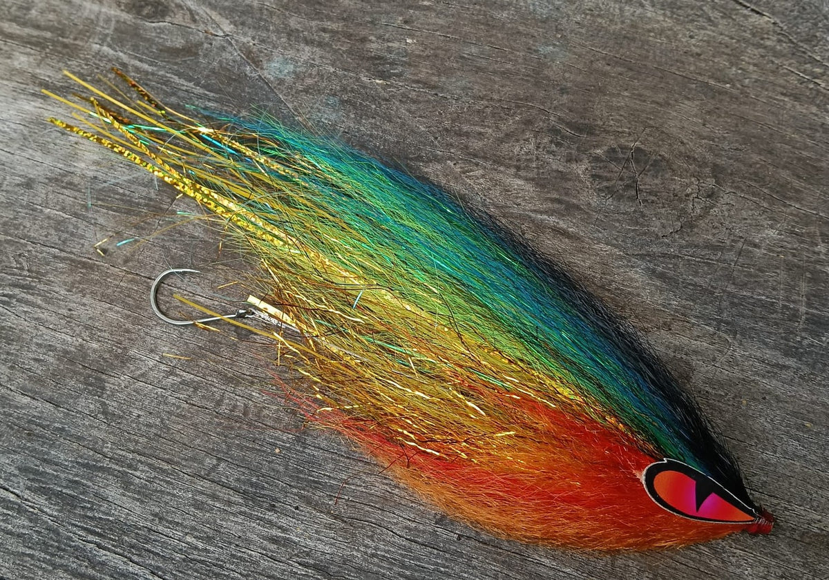 Figer Tiger hand-tied Payara Dragon Fly in green, yellow and orange with a red eye on a weathered wooden background